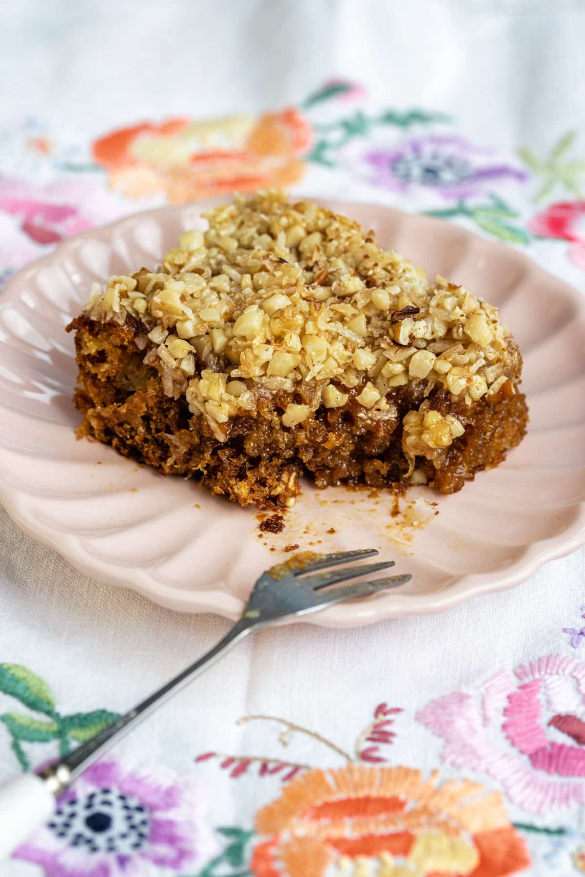 Slice of Do Nothing Cake on a plate with small bite taken