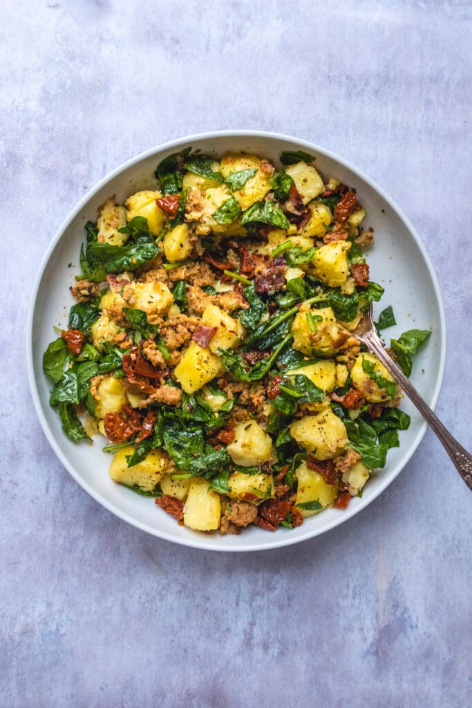 Warm potato salad with bacon, Italian sausage, sun dried tomatoes and spinach 