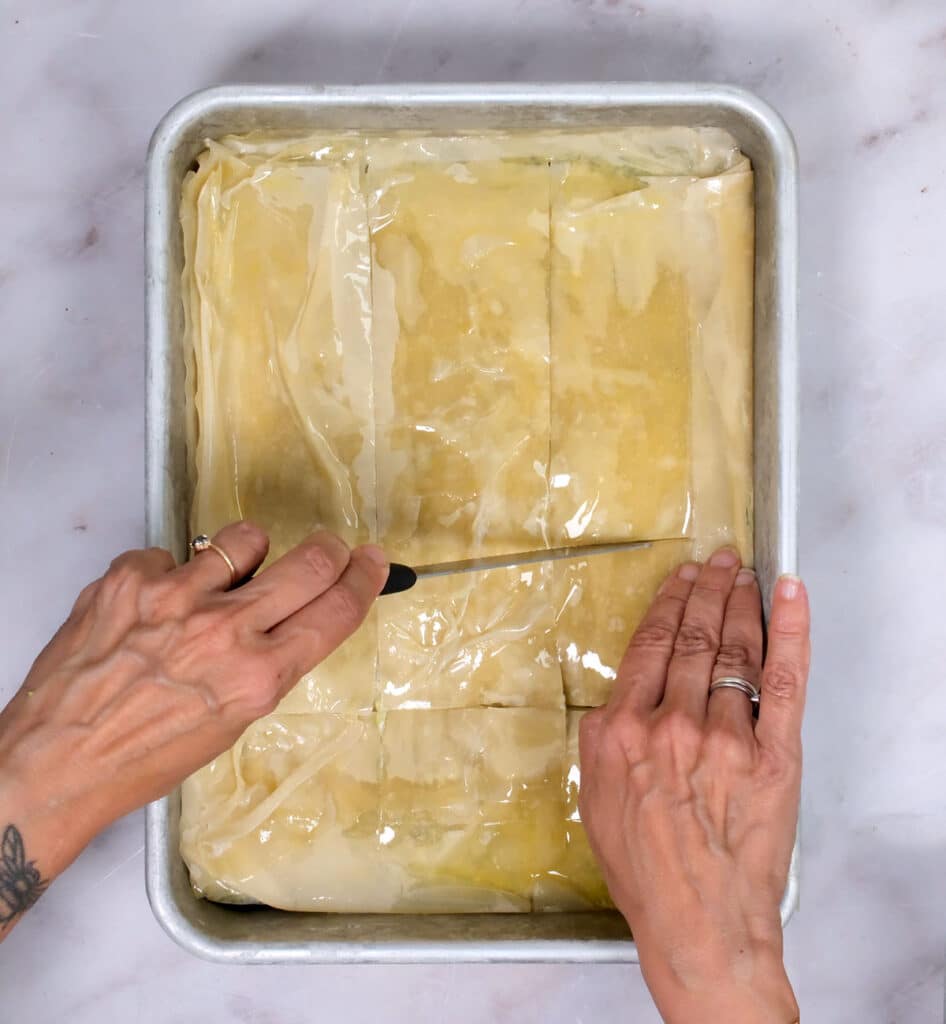scoring zucchini phyllo pie with a knife