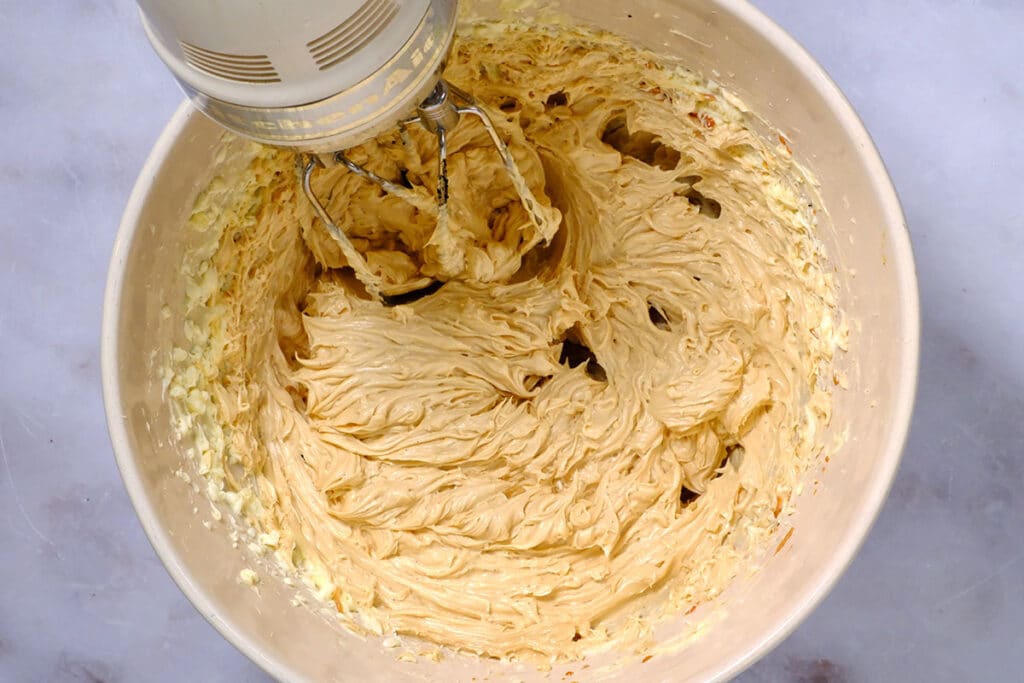Biscoff buttercream made with condensed milk and butter in a mixing bowl