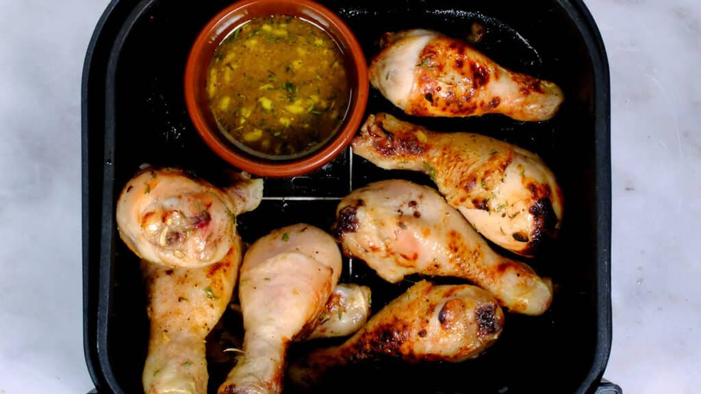 chicken drumsticks, partially cooked, in an air fryer