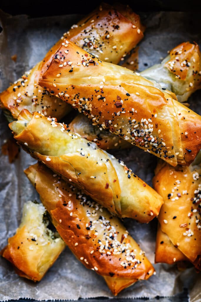 close up on spinach and feta filo rolls sprinkled with seeds