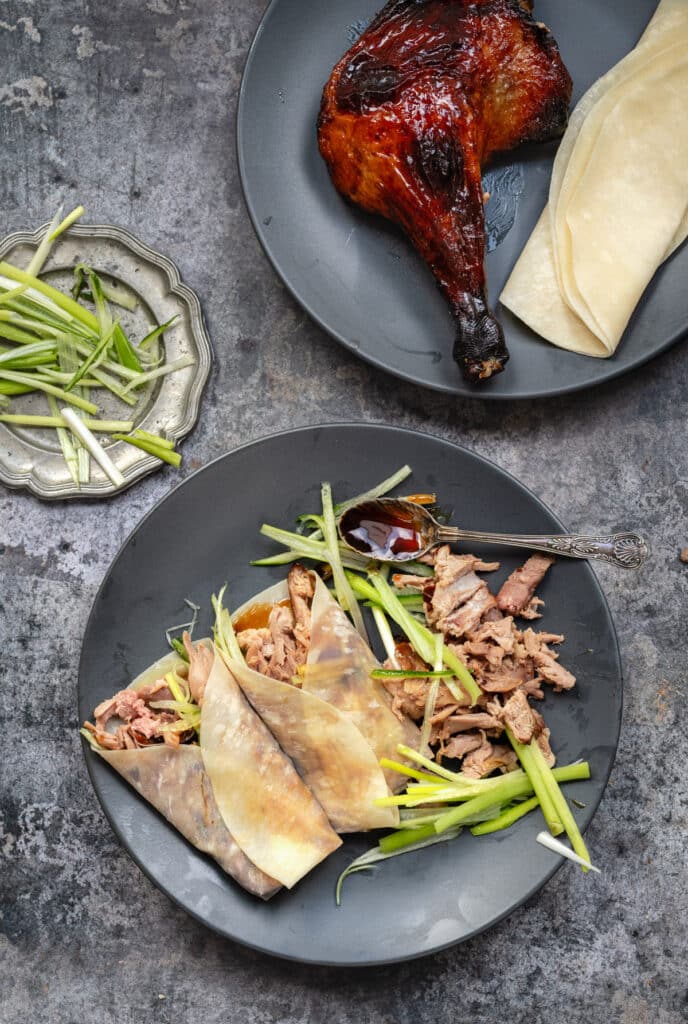Chinese aromatic crispy duck served in pancakes with Hoisin sauce, cucumber and spring onions