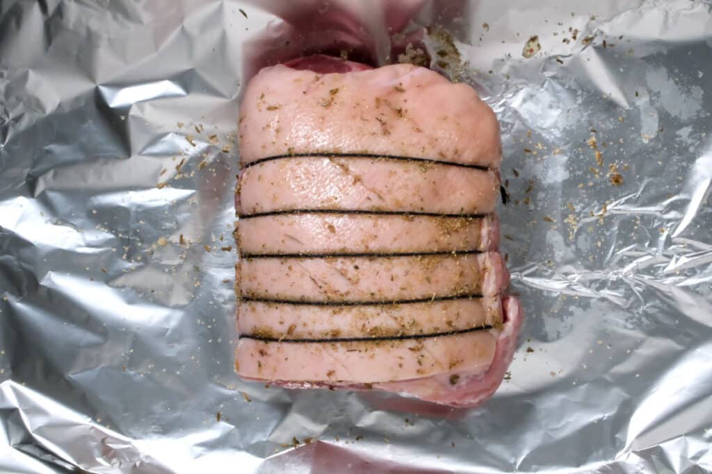 seasoned pork shoulder on top of kitchen foil