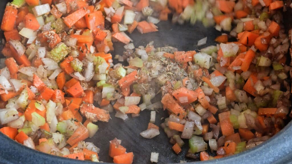 sauteing onion, celery and carrots close up