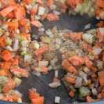sauteing onion, celery and carrots close up