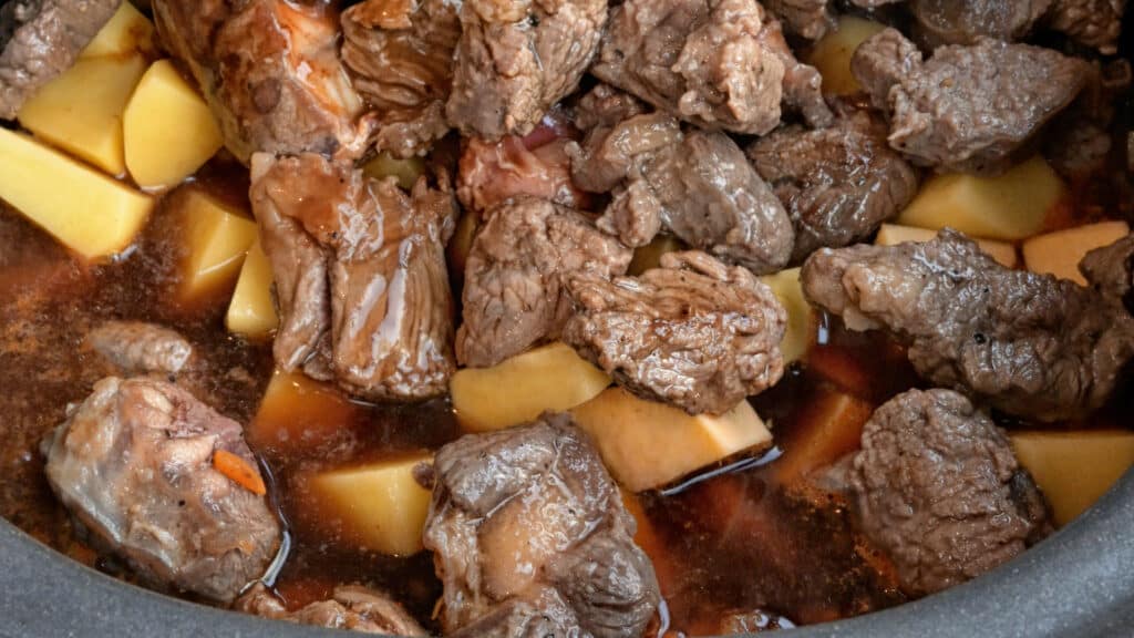 close up on lamb casserole with lamb and cubed potatoes