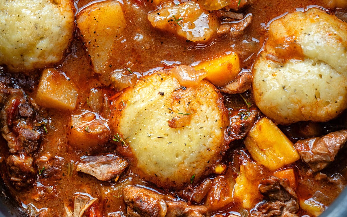 Close up on lamb casserole with dumplings in a slow cooker