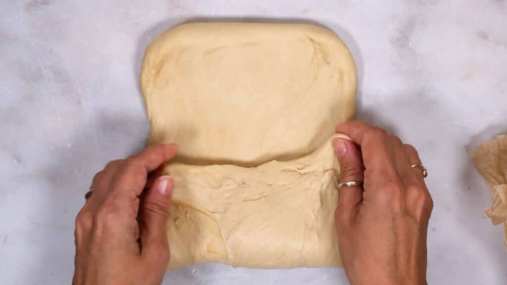 Folding bread dough into three sections