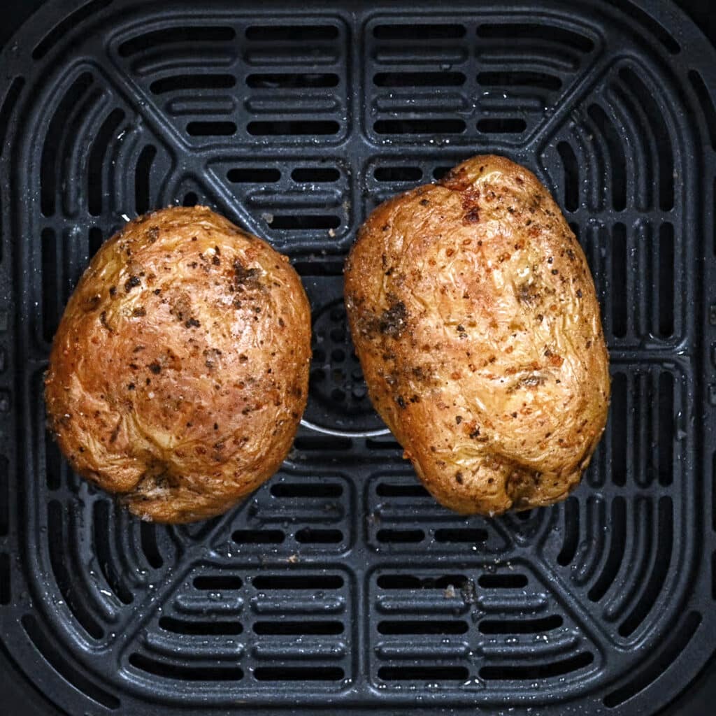 air fryer baked potatoes in the basket of an Instant Vortex air fryer