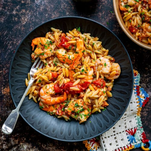 Shrimp and chorizo orzo served in a bowl