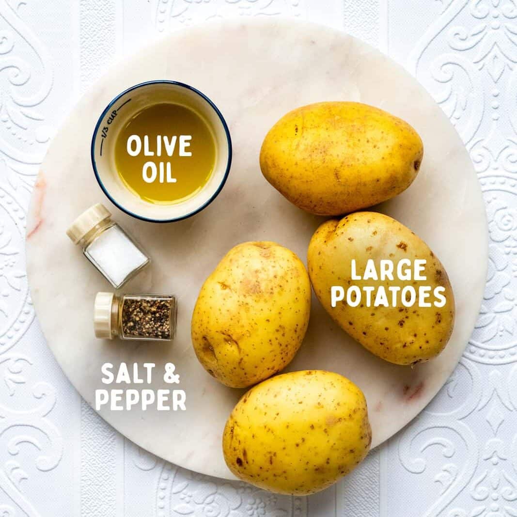 ingredients for baked potatoes on a white textured background