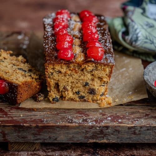 Mary Berry's Mincemeat Loaf Cake on a wooden board, one slice cut