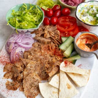 Air fryer doner served as a salad with lettuce, tomatoes, cucumber, onions, pita bread