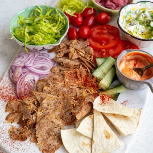 Air fryer doner served as a salad with lettuce, tomatoes, cucumber, onions, pita bread