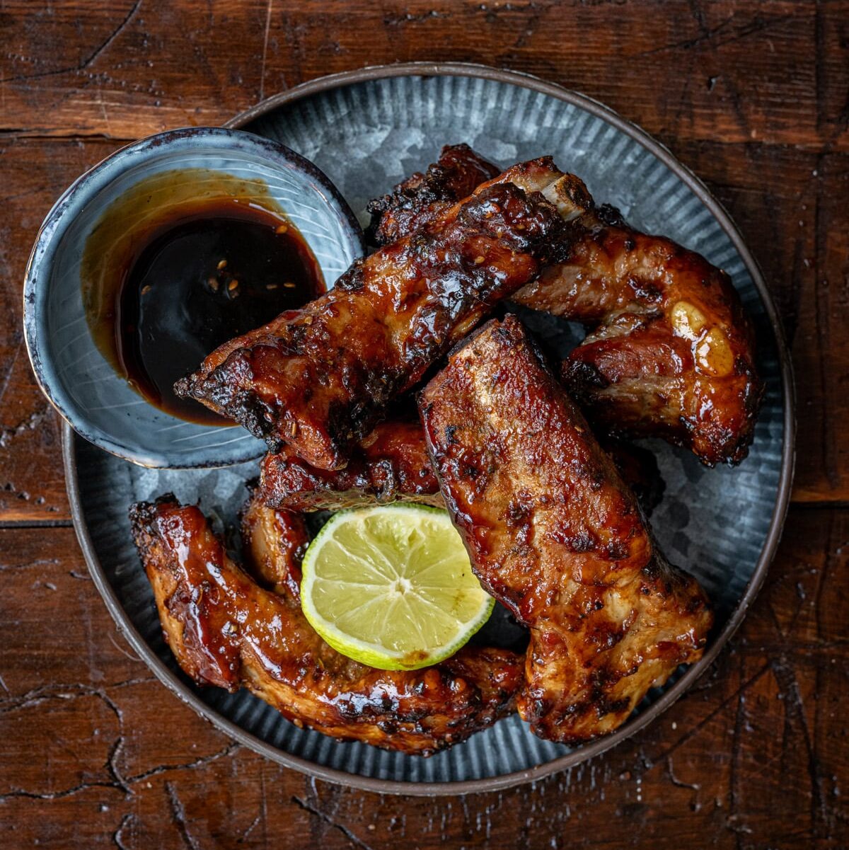 Plate of air fryer pork ribs with side of dipping sauce