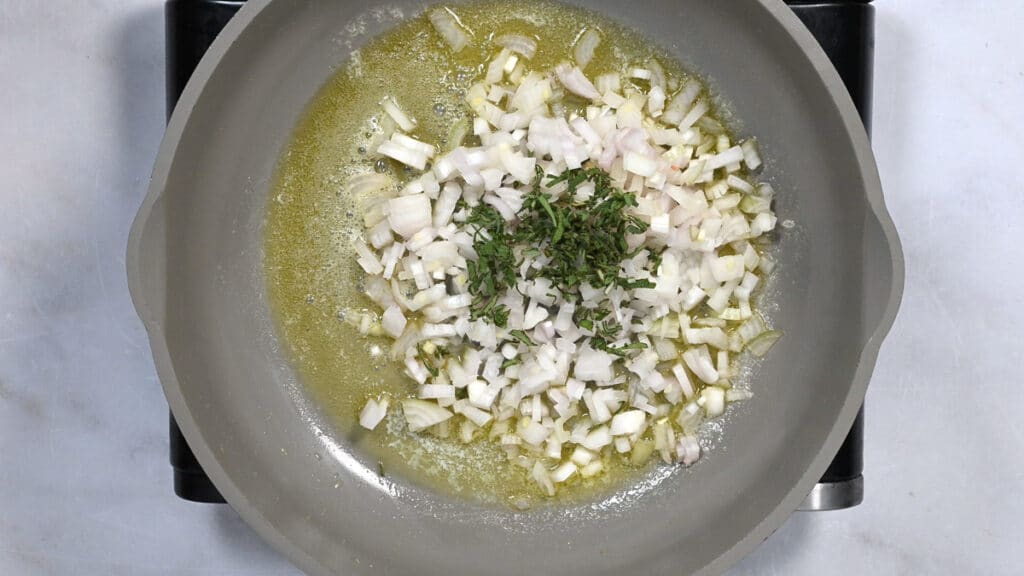 onions and sage cooking in a pan