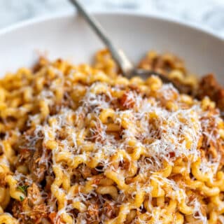 Close up on a bowl of pasta with ragu sauce