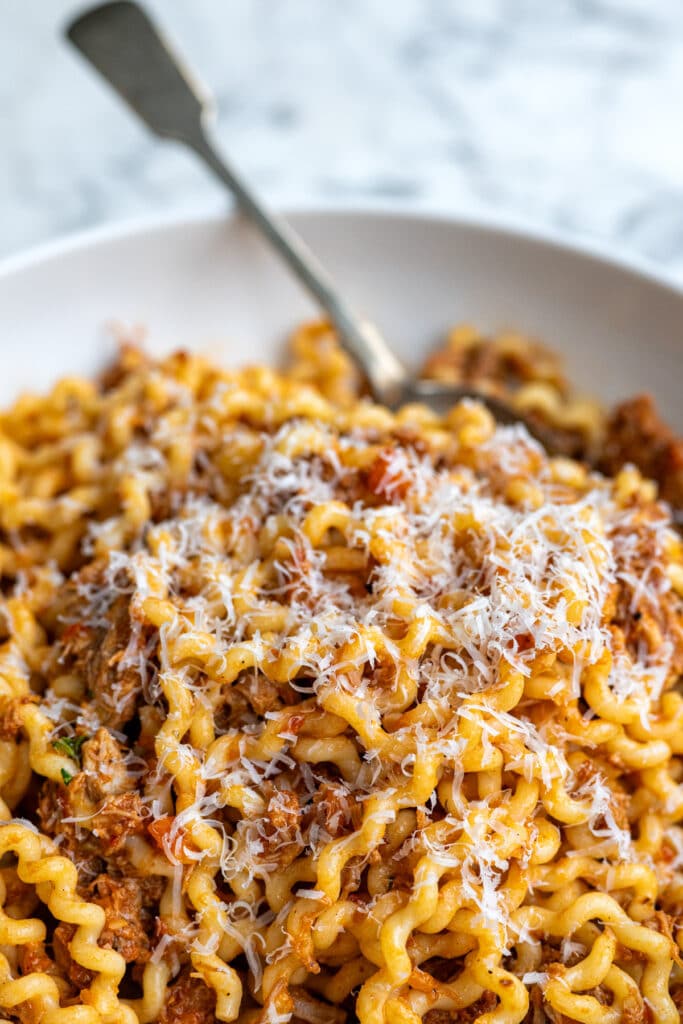 Close up on a bowl of pasta with ragu sauce
