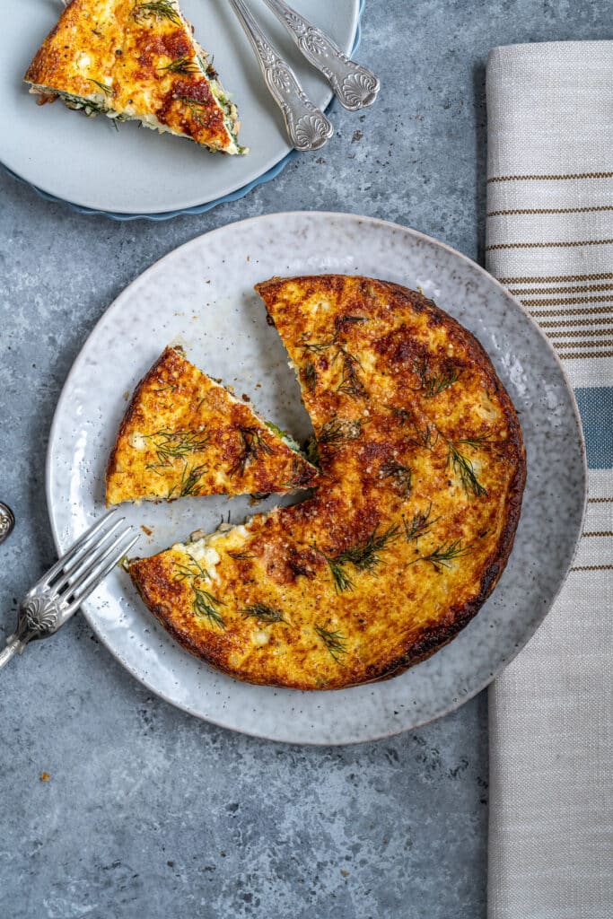 frittata with cottage cheese, salmon and spinach shown sliced on a plate