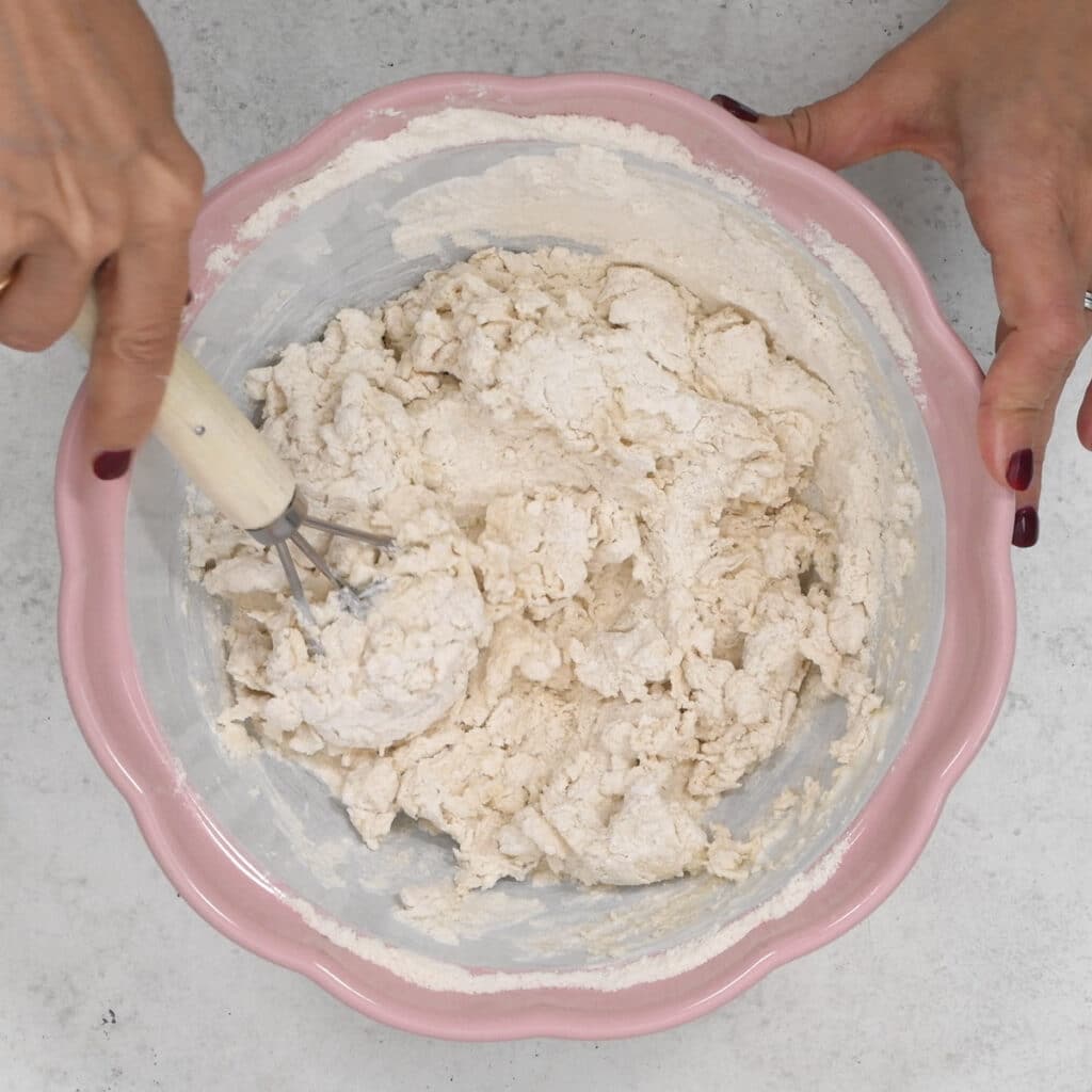 mixing the ingredients for three ingredient bread in a mixing bowl