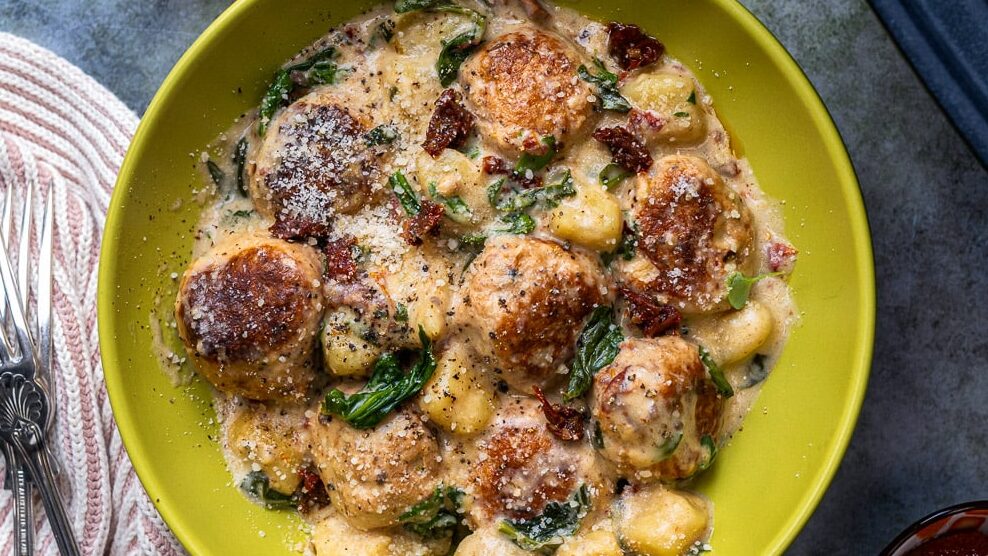 Chicken meatballs Tuscan style in a green bowl