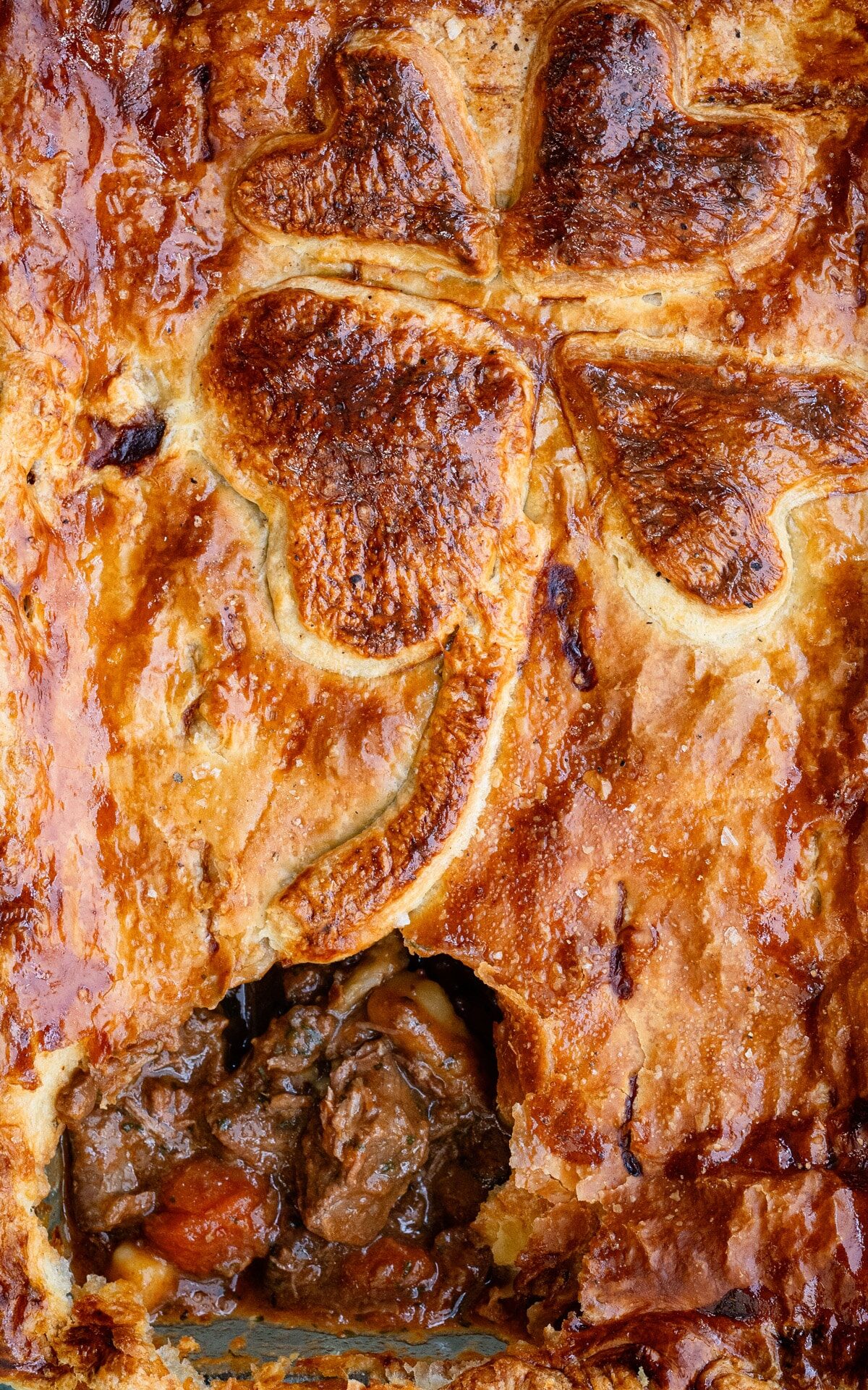 close up on the crust of a beef pie with puff pastry topping