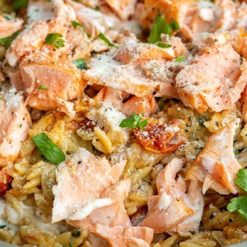 flaked salmon on a bed of Tuscan orzo cooked in a creamy garlic Parmesan sauce