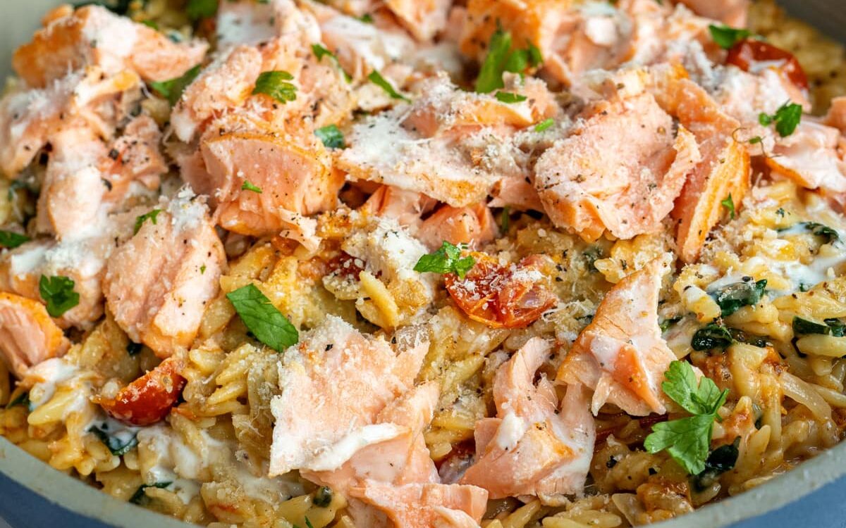 flaked salmon on a bed of  Tuscan orzo cooked in a creamy garlic Parmesan sauce 
