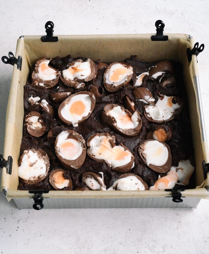 Brownies topped with Cadbury's Creme Eggs prior to baking