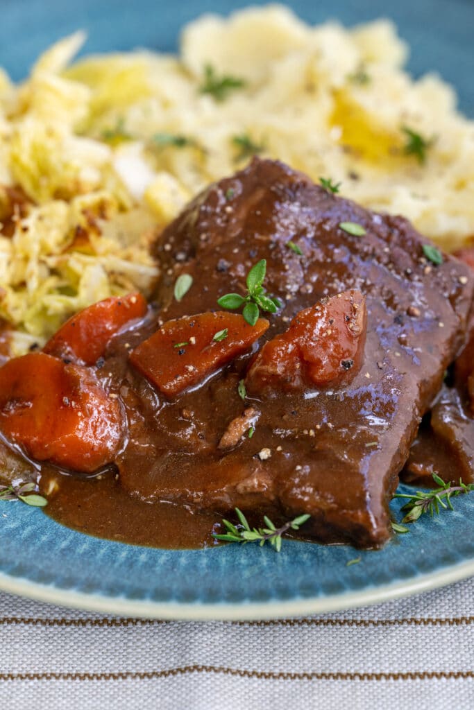 Braised steak and gravy served with mashed potatoes