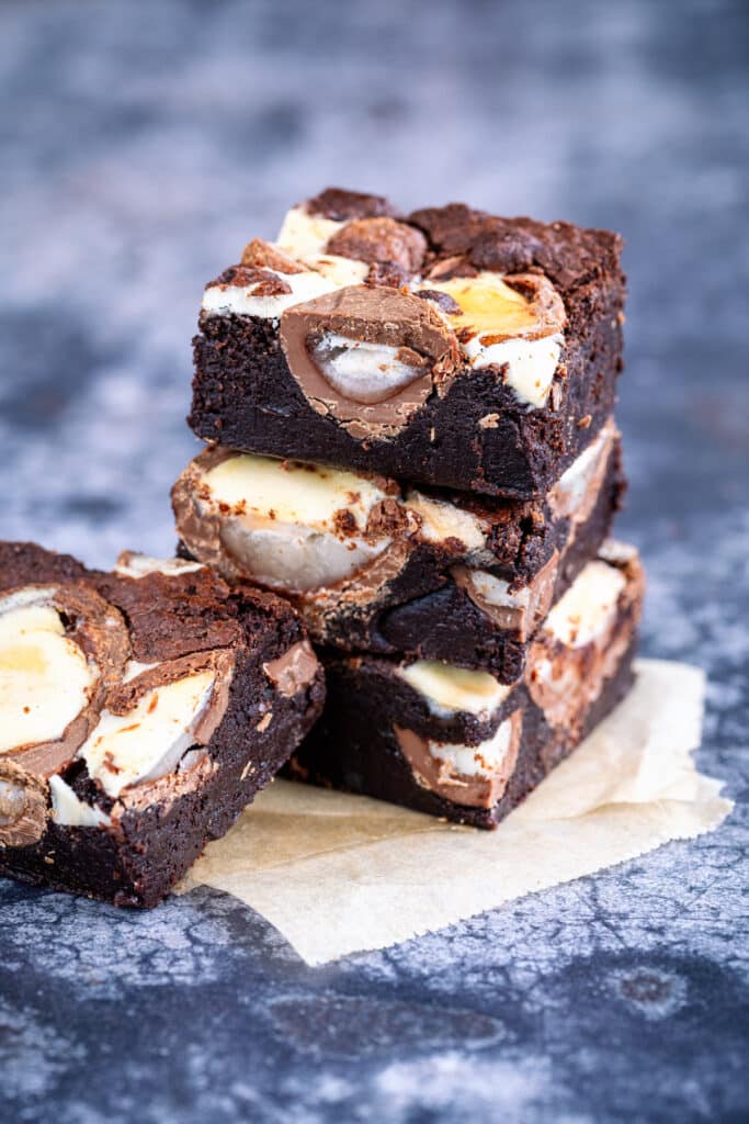 Sliced Creme Egg Brownies, three stacked, one on the side