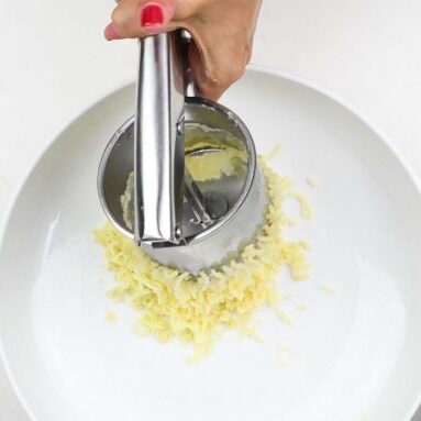 Using a potato ricer to make smooth mashed potatoes