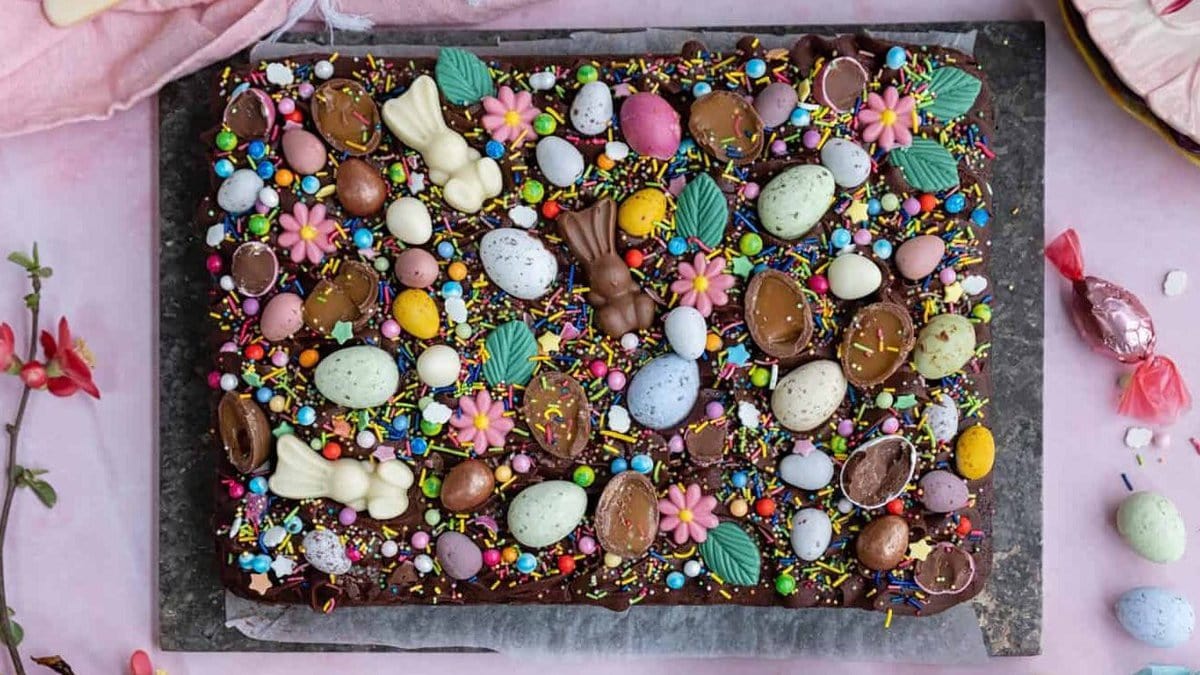 Easter tray bake cake with chocolate frosting and Easter candy decorations
