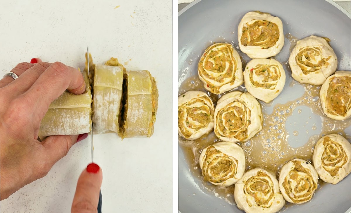 A hand slices rolled dough with filling on a white surface. Next to it, uncooked pinwheel-shaped dough pieces with filling are arranged in a round baking dish.
