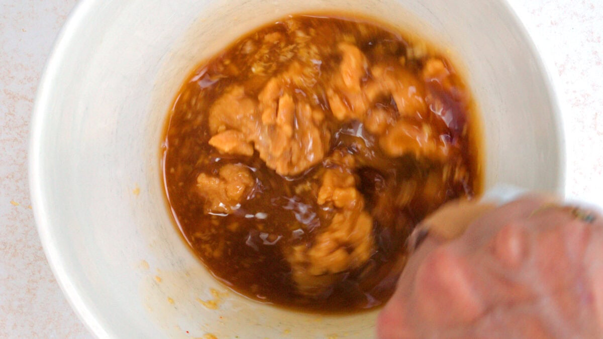 stirring miso marinade in a bowl