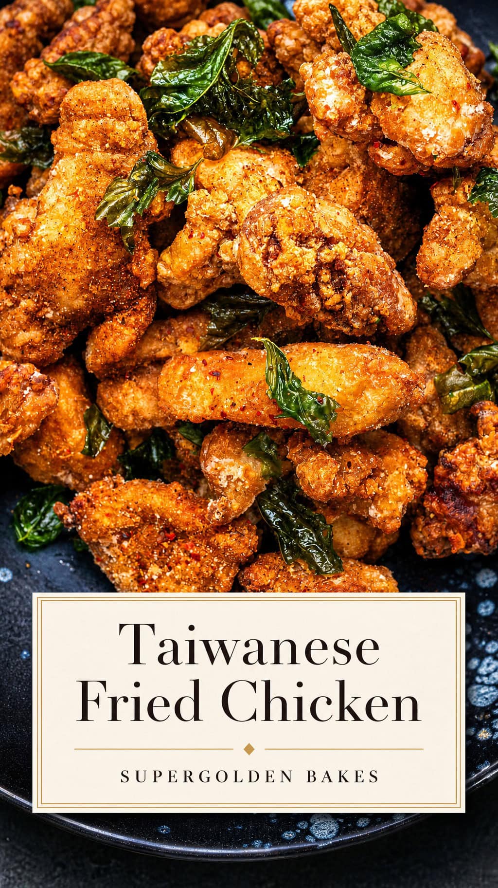 A plate of crispy Taiwanese fried chicken topped with fragrant fried basil leaves is shown in close up. A text overlay reads Taiwanese Fried Chicken, Supergolden Bakes.