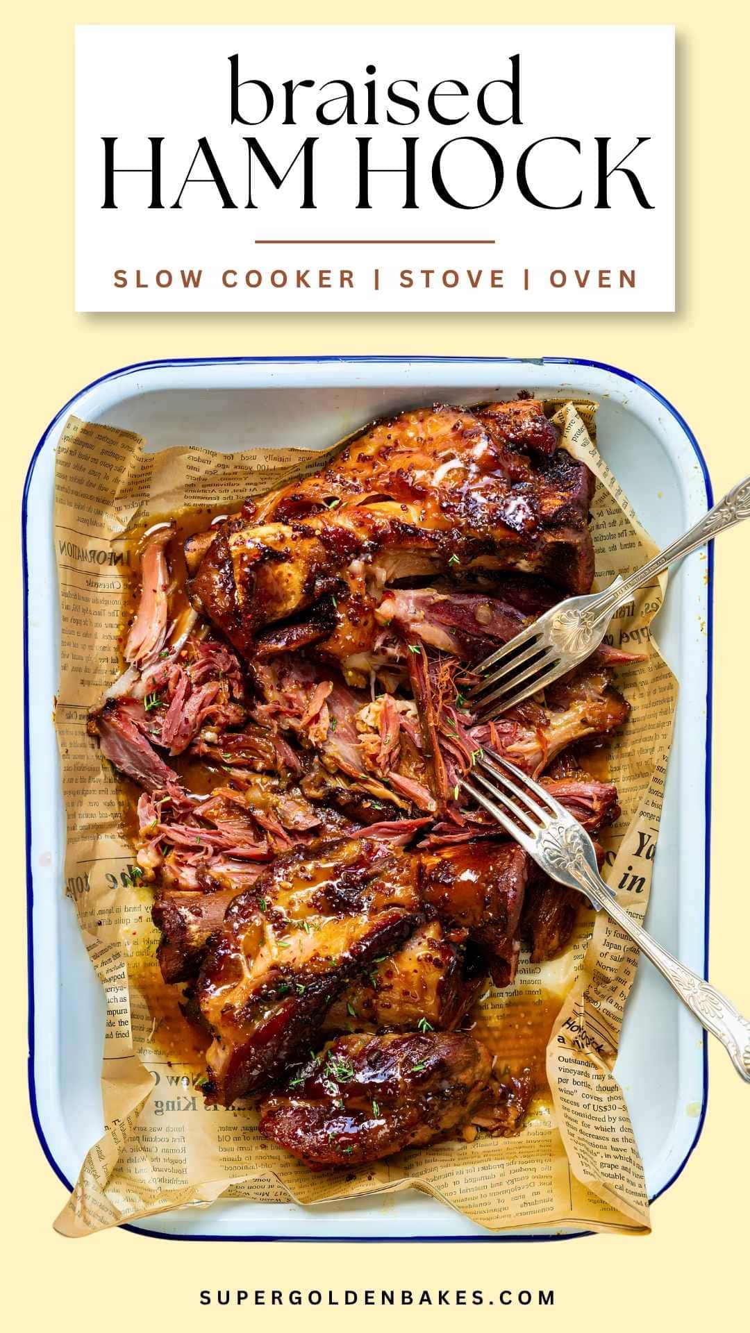 Pinterest pin for braised ham hock: glazed, pulled ham hock in a white enamel tray lined with paper, with two forks, and the text Braised Ham Hock – Slow Cooker, Stove, Oven.